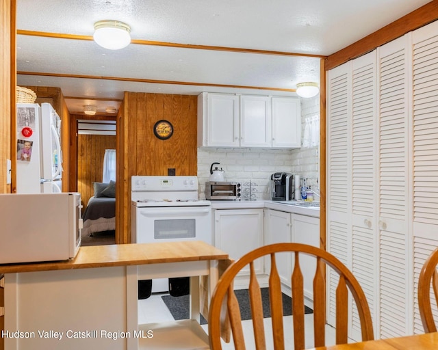 315 Begley Rd, Windham, NY 12496 - kitchen with white appliances, light countertops, white cabinetry, and tasteful backsplash