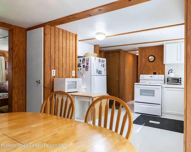 315 Begley Rd, Windham, NY 12496 - kitchen with white appliances, wood walls, light countertops, and white cabinetry