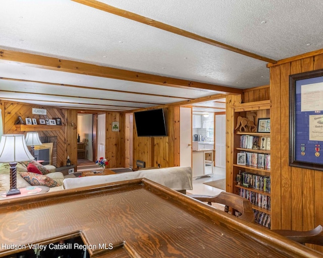 315 Begley Rd, Windham, NY 12496 - playroom with wood walls, beamed ceiling, and a textured ceiling
