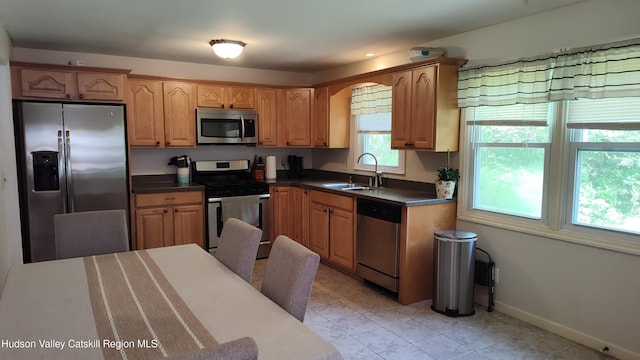 56 Church St, Plattekill, NY 12589 - kitchen featuring appliances with stainless steel finishes, a sink, dark countertops, and baseboards