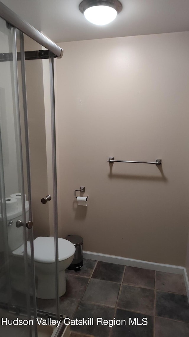 56 Church St, Plattekill, NY 12589 - bathroom featuring toilet, a stall shower, and baseboards