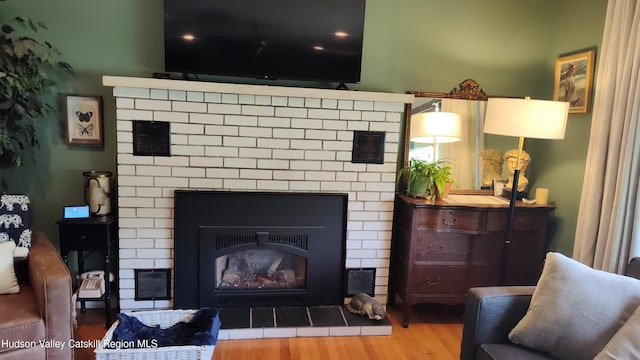 56 Church St, Plattekill, NY 12589 - living room featuring a brick fireplace and wood finished floors