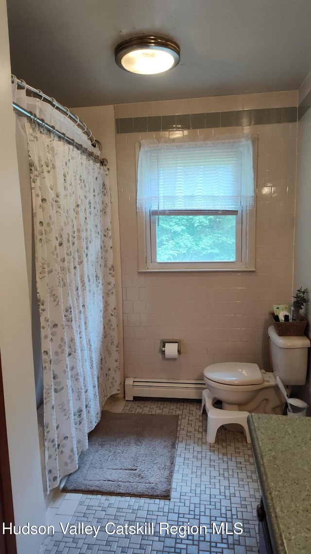 56 Church St, Plattekill, NY 12589 - bathroom featuring baseboard heating, toilet, vanity, curtained shower, and tile patterned floors