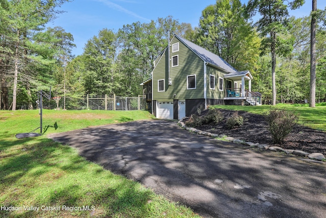 view of side of property with a yard and a garage