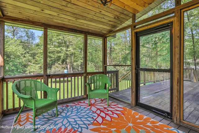 unfurnished sunroom featuring wooden ceiling and vaulted ceiling