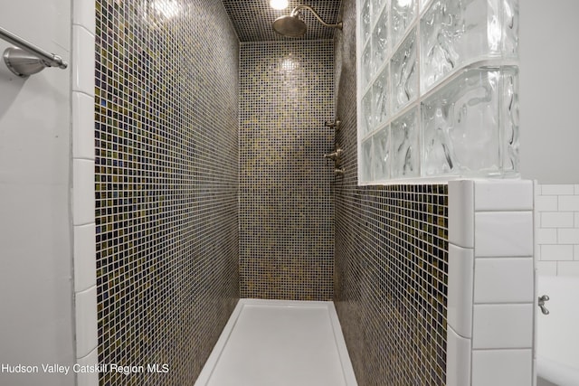 bathroom with a tile shower