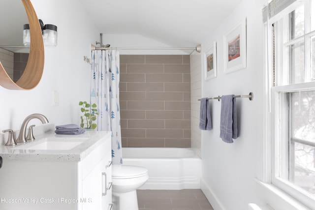 full bath with lofted ceiling, shower / bath combo with shower curtain, vanity, and toilet