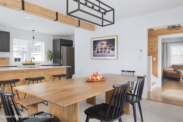 dining space with plenty of natural light and light wood-type flooring