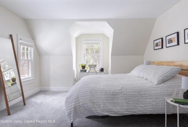 bedroom with baseboards, vaulted ceiling, carpet flooring, and multiple windows