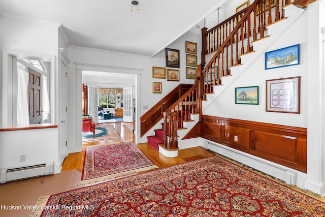 stairs with crown molding and baseboard heating