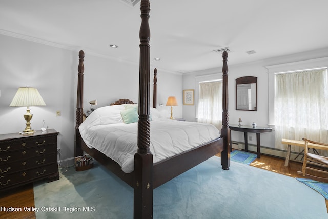 bedroom featuring crown molding, baseboards, baseboard heating, and visible vents
