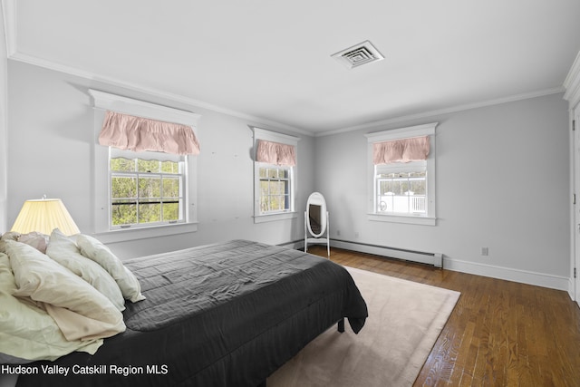bedroom featuring visible vents, multiple windows, ornamental molding, and a baseboard radiator