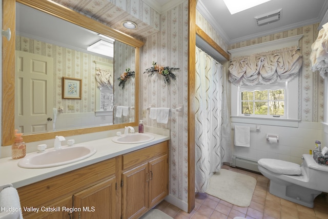 bathroom with a sink, toilet, wallpapered walls, and visible vents