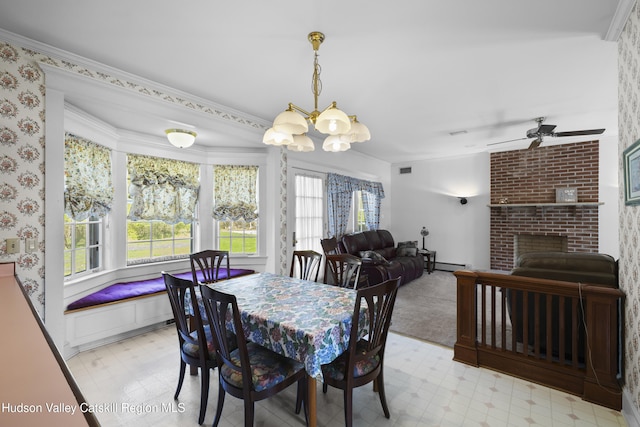 dining space with a fireplace, light floors, baseboard heating, wallpapered walls, and ceiling fan with notable chandelier