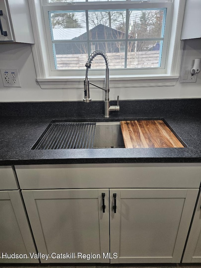 interior details featuring dark countertops and a sink