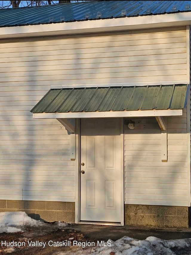 property entrance with metal roof