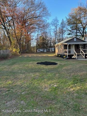 view of yard featuring covered porch