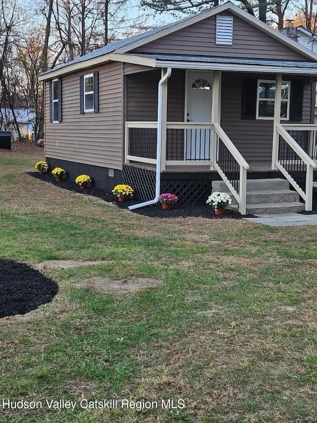 view of front facade featuring covered porch and a front yard