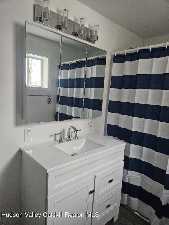 full bath with vanity and a shower with shower curtain