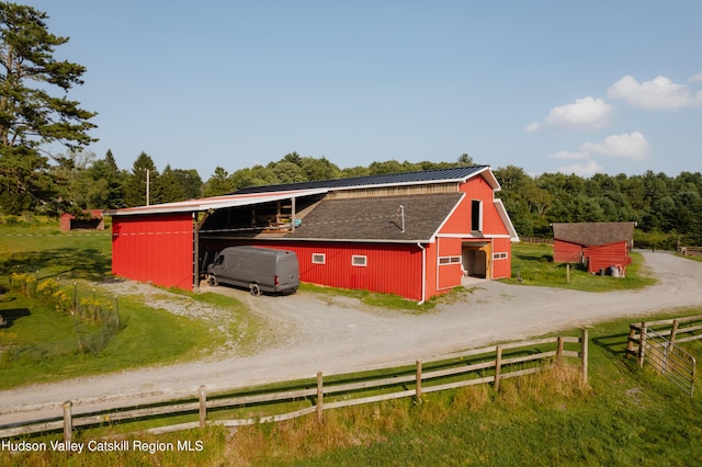 exterior space featuring a rural view and an outdoor structure