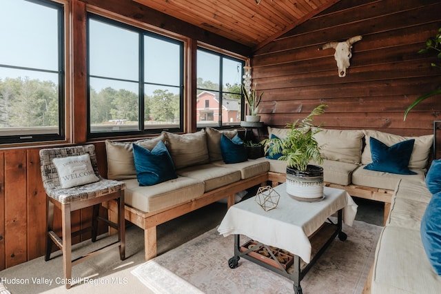 sunroom / solarium with a wealth of natural light, wood ceiling, and lofted ceiling