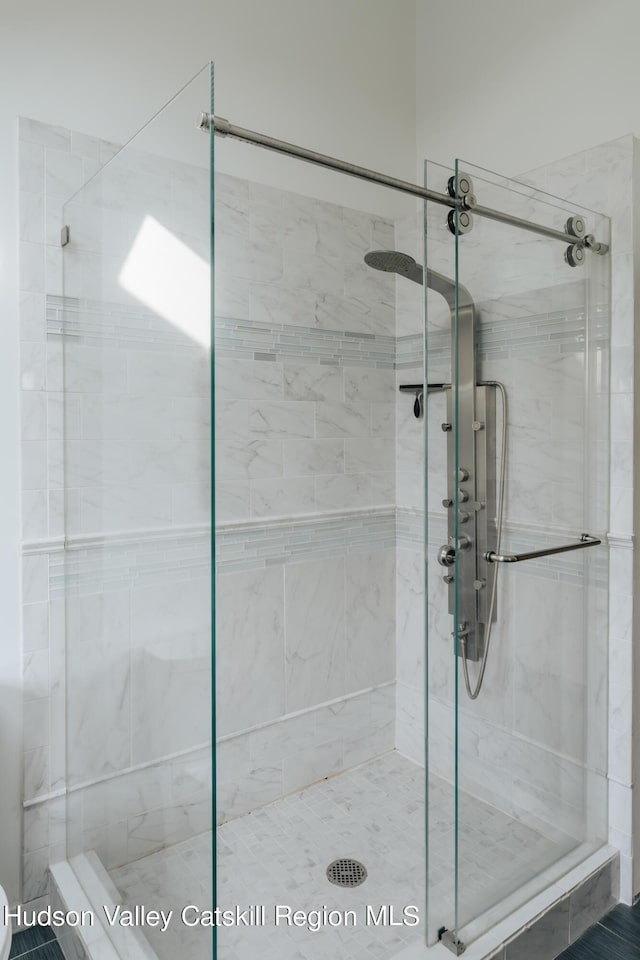 bathroom with a shower with shower door