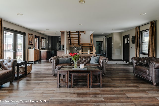 living room with a wealth of natural light and hardwood / wood-style flooring