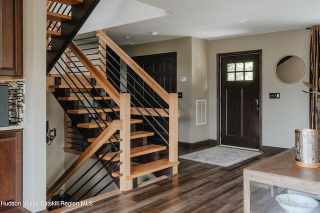 entryway with dark hardwood / wood-style floors