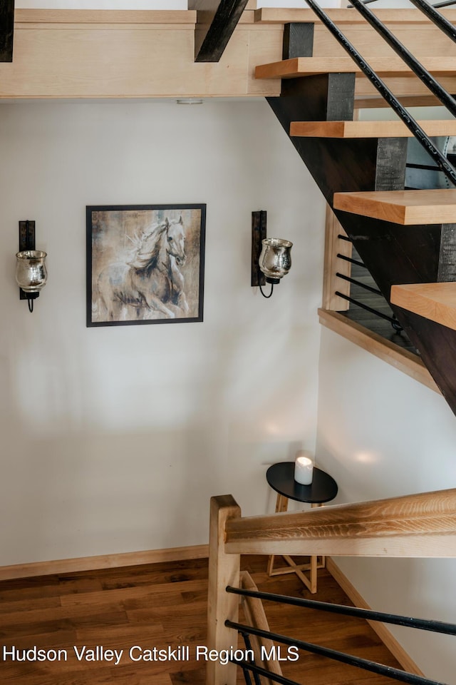 staircase with hardwood / wood-style flooring