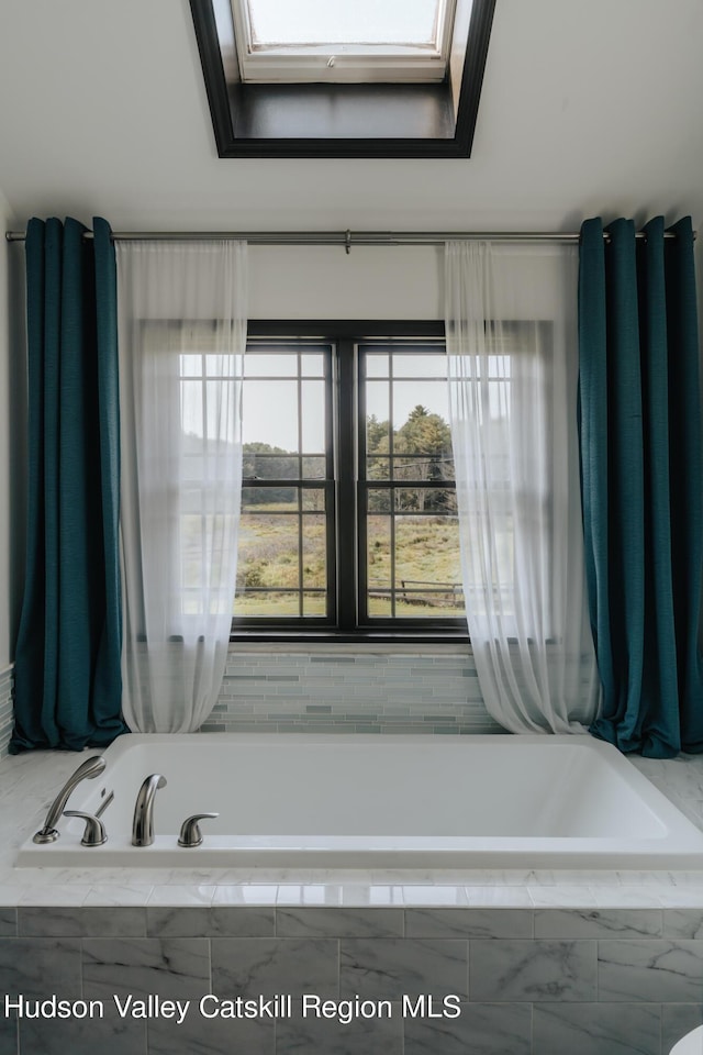 bathroom featuring a skylight