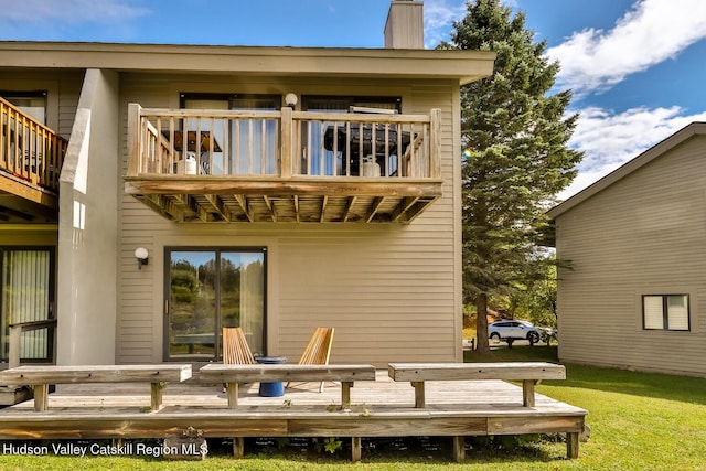 28 Loo Bridge Ln Unit 22A, Windham, NY 12496 - rear view of property with a balcony, a chimney, and a lawn