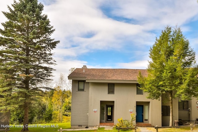 28 Loo Bridge Ln Unit 22A, Windham, NY 12496 - rear view of house featuring a chimney, a yard, and a shingled roof