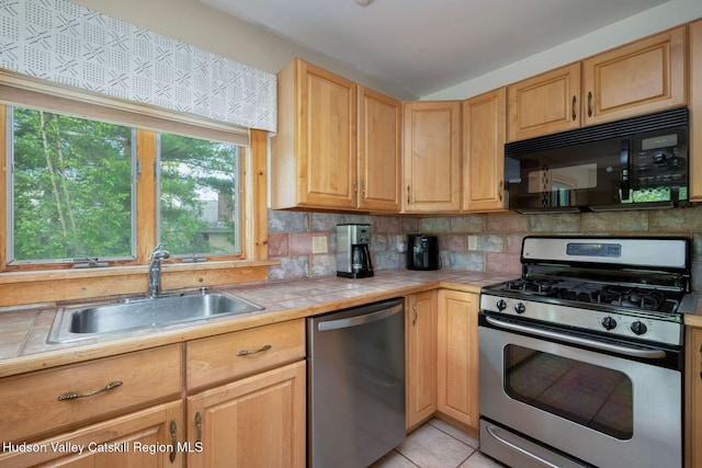 59 Mountain Dr, Hunter, NY 12442 - kitchen featuring appliances with stainless steel finishes, tile countertops, light brown cabinetry, tasteful backsplash, and light tile patterned floors