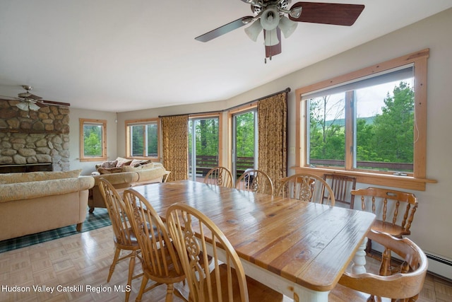 59 Mountain Dr, Hunter, NY 12442 - dining area with a ceiling fan, baseboard heating, and a fireplace