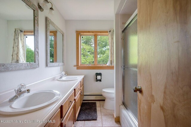 59 Mountain Dr, Hunter, NY 12442 - full bathroom featuring a baseboard heating unit, double vanity, tile patterned floors, and bath / shower combo with glass door