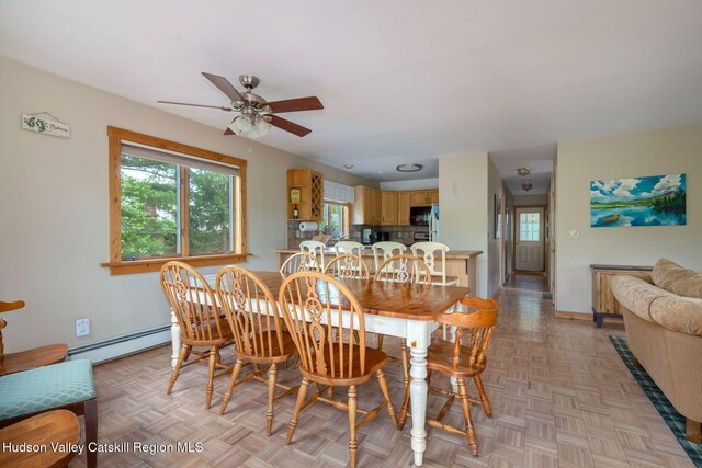 59 Mountain Dr, Hunter, NY 12442 - dining room featuring a baseboard radiator, a ceiling fan, and plenty of natural light