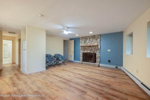 59 Mountain Dr, Hunter, NY 12442 - unfurnished living room featuring a baseboard radiator, wood finished floors, ceiling fan, a fireplace, and recessed lighting
