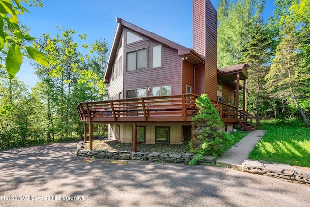 59 Mountain Dr, Hunter, NY 12442 - rear view of property featuring a chimney, a deck, and stairs