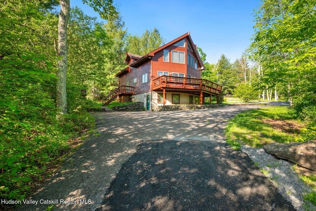 59 Mountain Dr, Hunter, NY 12442 - view of side of home featuring a deck, asphalt driveway, and stairway