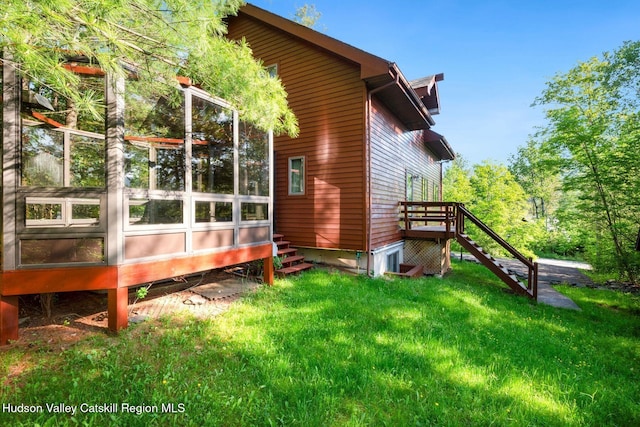 59 Mountain Dr, Hunter, NY 12442 - view of side of property with stairway, a sunroom, and a yard