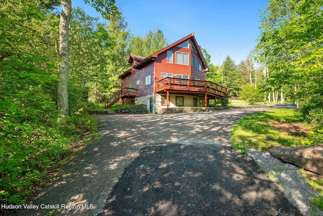 59 Mountain Dr, Hunter, NY 12442 - view of side of home featuring a deck, asphalt driveway, and stairway