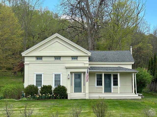 2456 State Route 82, Ancram, NY 12502 - neoclassical / greek revival house featuring a front lawn, covered porch, and roof with shingles