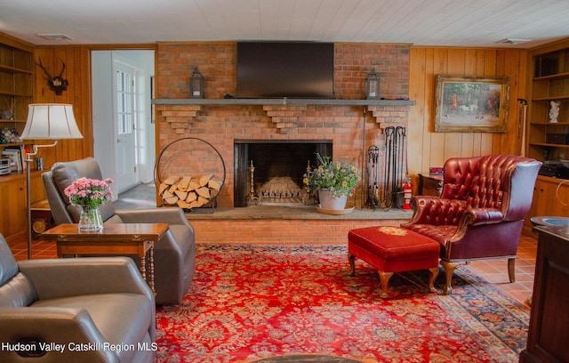 living room featuring wooden ceiling, a brick fireplace, tile patterned flooring, built in features, and wooden walls