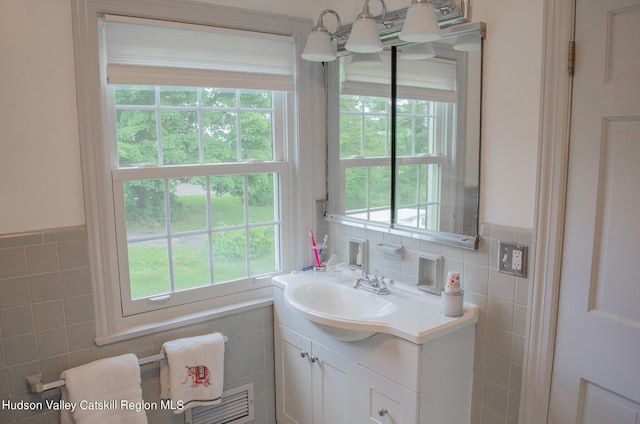 bathroom featuring tile walls and a healthy amount of sunlight