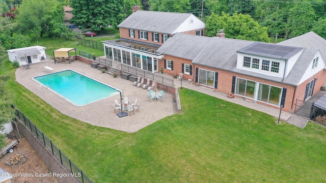 view of swimming pool with an outdoor structure, a patio area, and a yard