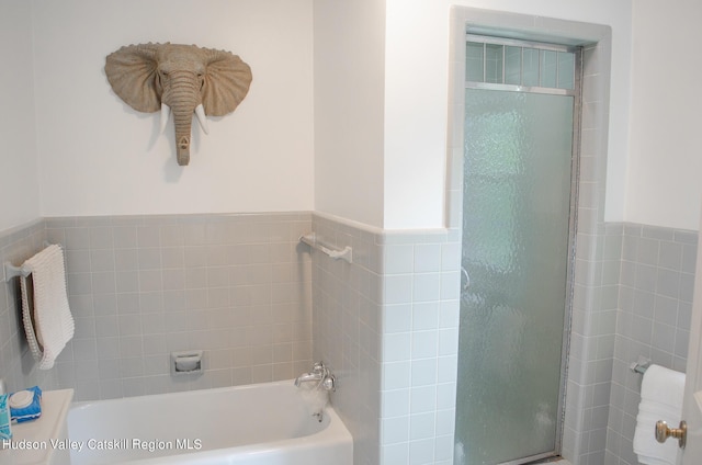 bathroom with shower with separate bathtub