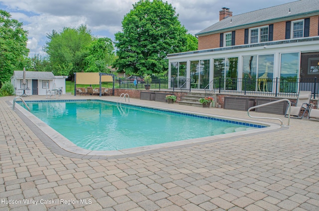 view of pool featuring a patio area and an outdoor structure