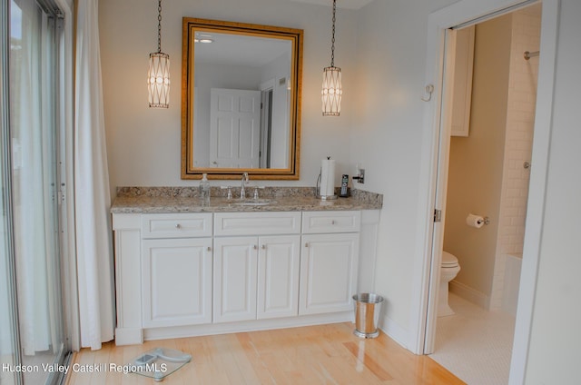 full bathroom featuring wood-type flooring, vanity, toilet, and shower / bathtub combination