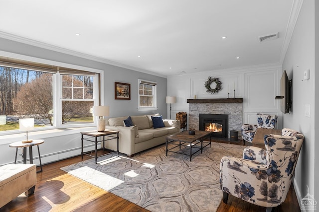 30 Clinton Hollow Rd, Pleasant Valley, NY 12578 - living area featuring wood finished floors, baseboard heating, a stone fireplace, crown molding, and recessed lighting