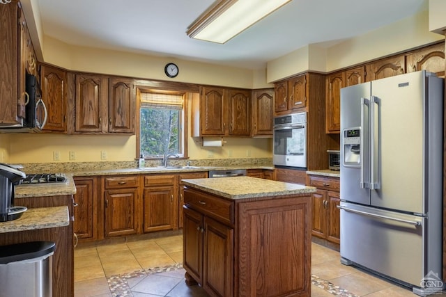 213 Botti Dr, Hunter, NY 12442 - kitchen featuring appliances with stainless steel finishes, light tile patterned floors, a kitchen island, and light stone countertops
